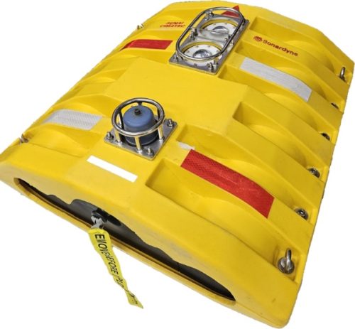 Picture of an On Demand Ocean Bottom Node. A yellow, half cylindrical object with a flat base and sensors protruding from the top 